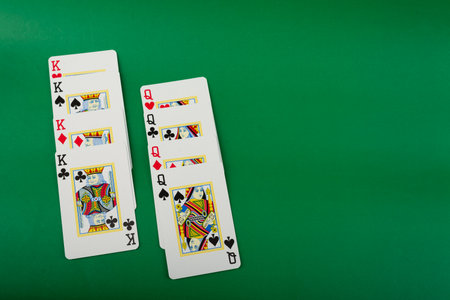 Salvador, Bahia, Brazil - May 10, 2024: Playing cards isolated on green background. Gambling.のeditorial素材