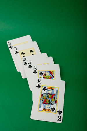 Salvador, Bahia, Brazil - May 10, 2024: Playing cards for poker and gambling, isolated on green background.のeditorial素材