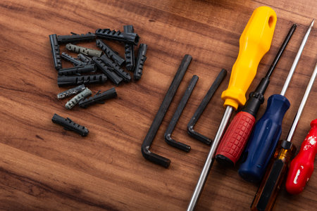 Pliers, screwdriver, wrench and other tools isolated on wooden background.の写真素材
