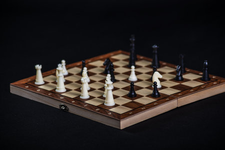 Chess board with light and dark pieces. Game concepts. Board game. Hobby. Chess on the playing field for a game on a black background.の写真素材