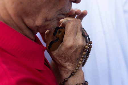 Salvador, Bahia, Brazil - July 27, 2024: Detail of the hands of a Catholic believer seen during mass in Pelourinho, historic center of the city of Salvador, Bahia.のeditorial素材