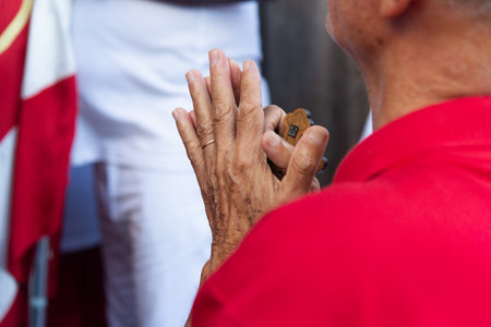 Salvador, Bahia, Brazil - July 27, 2024: Detail of the hands of a Catholic believer seen during mass in Pelourinho, historic center of the city of Salvador, Bahia.のeditorial素材