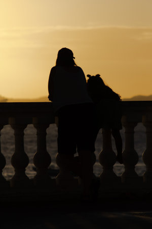 Salvador, Bahia, Brazil - June 15, 2019: An unidentified person is seen in silhouette enjoying the sunset at Porto da Barra in the city of Salvador, Bahia.のeditorial素材