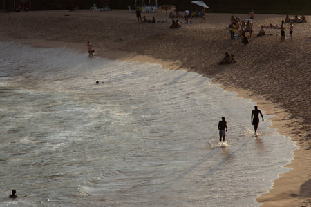 Salvador, Bahia, Brazil - July 06, 2019: People have fun and sunbathe and swim in the sea at Paciencia beach during a sunny day in the city of Salvador, Bahia.のeditorial素材