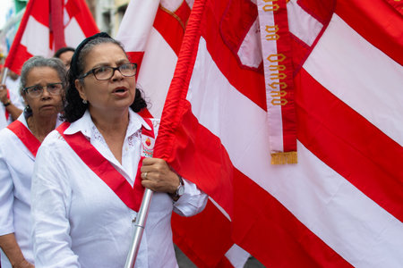 Salvador, Bahia, Brazil - July 27, 2019: Catholic faithful are seen carrying flags during the Sacred Heart of Jesus procession in the historic center of the city of Salvador, Bahia.のeditorial素材