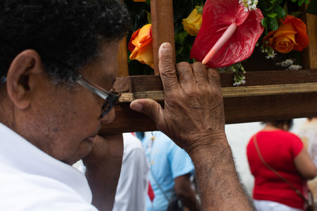 Salvador, Bahia, Brazil - July 27, 2019: Catholic faithful are seen carrying a float during the Sacred Heart of Jesus procession in the historic center of the city of Salvador, Bahia.のeditorial素材