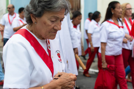 Salvador, Bahia, Brazil - July 27, 2019: Catholic faithful are seen carrying flags during the Sacred Heart of Jesus procession in the historic center of the city of Salvador, Bahia.のeditorial素材