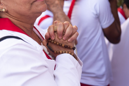Salvador, Bahia, Brazil - July 27, 2024: Hands of a Catholic faithful holding a rosary during mass in Pelourinho, historic center of the city of Salvador, Bahia.のeditorial素材