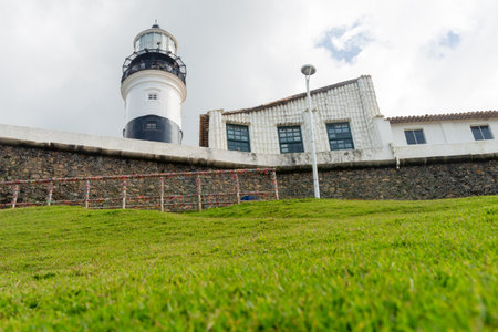 Salvador, Bahia, Brazil - September 01, 2024: Low view of the Barra Lighthouse, during a cloudy day, located in the Barra neighborhood in the city of Salvador, Bahia.のeditorial素材