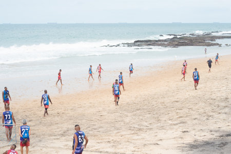 Salvador, Bahia, Brazil - September 01, 2024: Players are seen playing beach soccer on Farol da Barra beach during cold weather. Salvador, Bahia.のeditorial素材