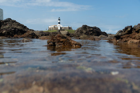 Salvador, Bahia, Brazil - September 01, 2024: Low view of the Barra Lighthouse, during a cloudy day, located in the Barra neighborhood in the city of Salvador, Bahia.のeditorial素材