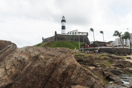 Salvador, Bahia, Brazil - September 01, 2024: Low view of the Barra Lighthouse, during a cloudy day, located in the Barra neighborhood in the city of Salvador, Bahia.のeditorial素材