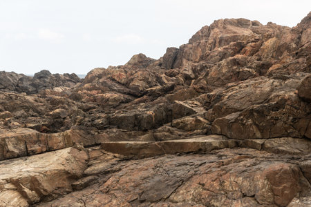 Huge dark and slippery rocks against the cloudy sky. Untouched nature. Salvador, Brazilの写真素材