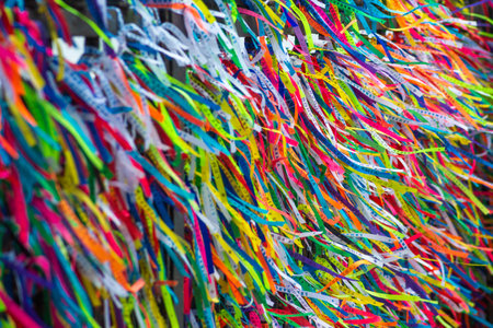 Salvador, Bahia, Brazil - December 27, 2019: Several colorful ribbons of remembrance attached to the fence of the Senhor do Bonfim church in the city of Salvador, Bahia.のeditorial素材