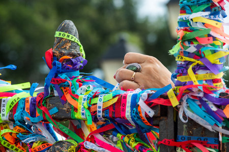 Salvador, Bahia, Brazil - December 27, 2019: Hands of Catholics are touching the colorful ribbons of remembrance of the church of Senhor do Bonfim in Salvador, Bahia.のeditorial素材