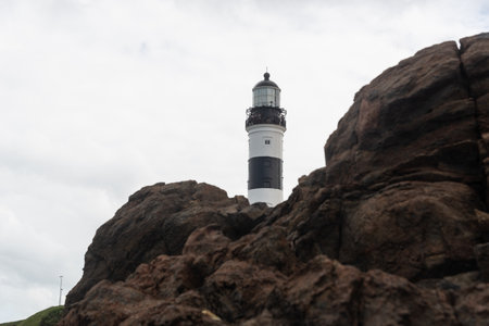 Salvador, Bahia, Brazil - September 01, 2024: Low view of the Barra Lighthouse, during a cloudy day, located in the Barra neighborhood in the city of Salvador, Bahia.のeditorial素材