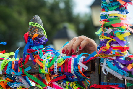 Salvador, Bahia, Brazil - December 27, 2019: Hands of Catholics are touching the colorful ribbons of remembrance of the church of Senhor do Bonfim in Salvador, Bahia.のeditorial素材