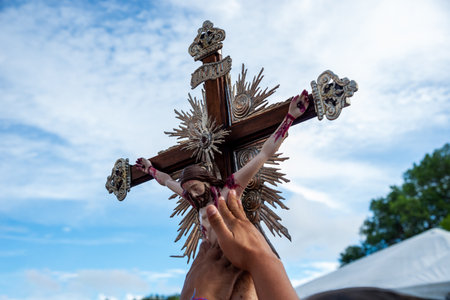 Salvador, Bahia, Brazil - December 27, 2019: Faithful touch the cross of Jesus Christ during mass at the Bonfim church in the city of Salvador, Bahia.のeditorial素材
