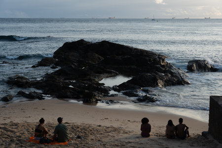 Salvador, Bahia, Brazil - September 14, 2024: People in silhouette are seen enjoying the sunset on Porto da Barra beach, in the city of Salvador, Bahia.のeditorial素材