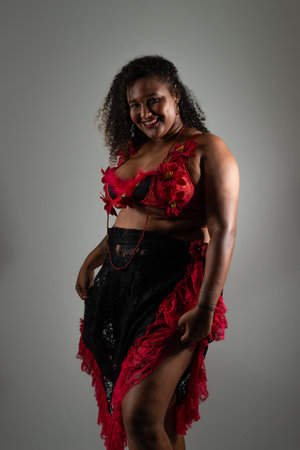 Salvador, Bahia, Brazil - October 21, 2024: Beautiful black woman standing wearing traditional gypsy clothing and posing for photo. Isolated on white background. Salvador, Bahia.の写真素材