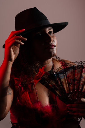 Salvador, Bahia, Brazil - October 21, 2024: Woman wearing traditional clothes, sitting, posing for a photo in a studio. Salvador, Bahia.の写真素材