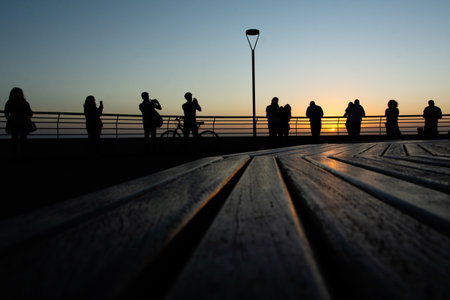 Salvador, Bahia, Brazil - September 19, 2019: A group of people, in silhouette, is seen enjoying the sunset in the city of Salvador, Bahia.の写真素材