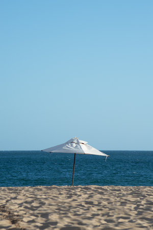 Umbrella on a beach with blue sky and sea in the background. Vacation concept. Fun.の写真素材