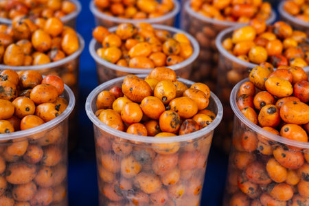 Seriguelas for sale at a market. Fruit source of fiber rich in vitamin C, flavonoids and carotenoids. Healthy eating conceptの写真素材