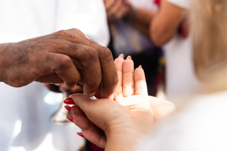 Catholics are seen receiving the host during mass on the last Friday of 2024. Bonfim Church, Salvador, Bahia.の写真素材