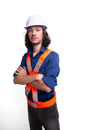 Young engineer wearing white helmet and luminous vest is posing for photo. Safety equipment. Architectの写真素材