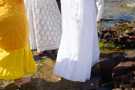 Candomble followers are seen on the rocks of Rio Vermelho beach paying homage to Iemanja. Salvador, Brazil.の写真素材