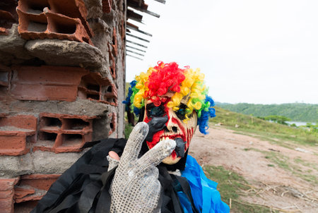 Unidentified person dressed in terrifying costume and mask. Rural cultural area. Carnival day in...