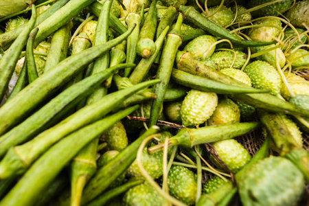 Green okra for sale at a street market. Fruit rich in dietary fiber, magnesium, manganese, phosphorus and zinc. Food for sale.の写真素材