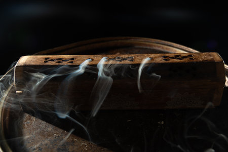Dancing incense smoke with light in the dark. Studio shot.の写真素材
