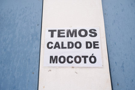 A computer-printed sign reading We Have Caldo de Mocoto on the wall of a business. Santo Amaro, Bahia, Brazil.の写真素材