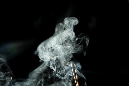 Dancing incense smoke with light in the dark. Studio shot.の写真素材