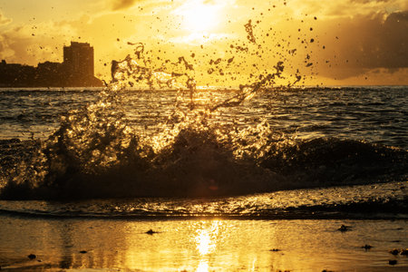 Waves crashing with splash on the shore of a beach at sunrise. Dramatic landscape. Environment. Brazilの写真素材