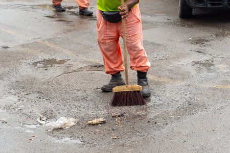 Cleaning worker cleaning the floor of a street. Concept of public hygiene and care. Brazilの写真素材