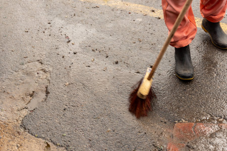 Cleaning worker cleaning the floor of a street. Concept of public hygiene and care. Brazilの写真素材