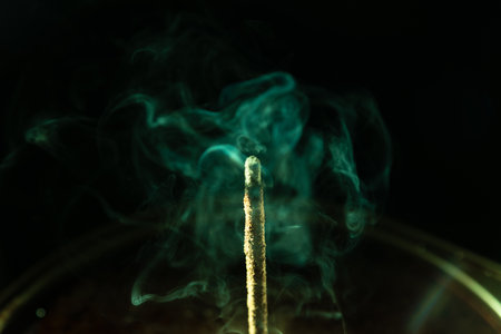 Abstract swirling incense smoke in soft green tones. Studio shot.の写真素材