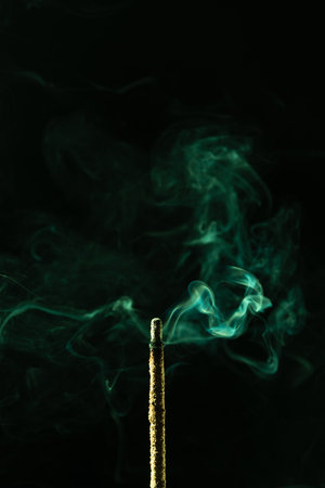 Abstract swirling incense smoke in soft green tones. Studio shot.の写真素材