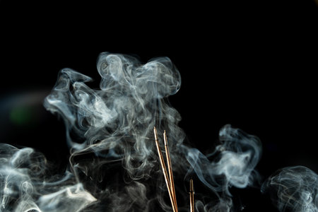 Dancing incense smoke with light in the dark. Studio shot.の写真素材