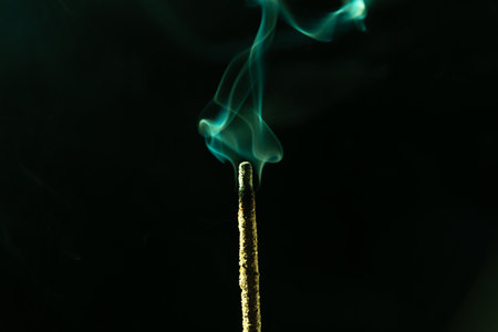 Abstract swirling incense smoke in soft green tones. Studio shot.の写真素材