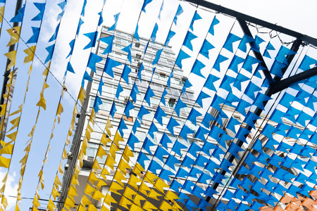 Decoration of the June festival with colorful flags. Plastic objects attached to the top. Pelourinho, Brazil.の写真素材