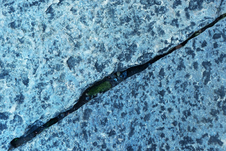 Close-up of a street floor with cracks in the shape of a line. Texture, background for work. copy, space, abstract.の写真素材