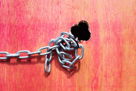 Red wood texture with tied chains. Geometric pattern. Background. Abstract. Copy space. door