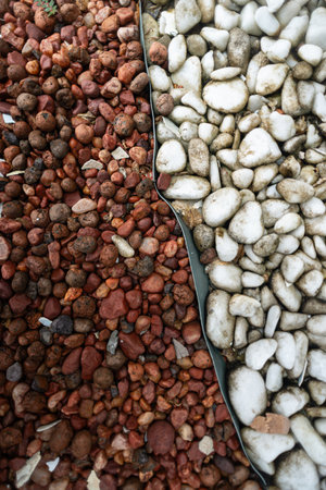 Frame full of decorative brown and white stones. Texture. Background. Geometry.