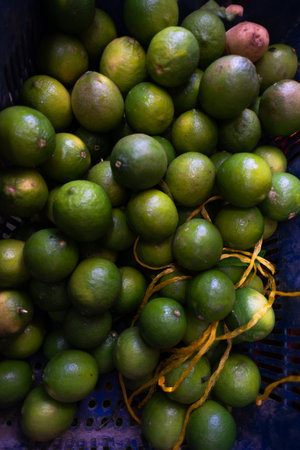 Green lemons on display for sale at a traditional Brazilian fair. Healthy food. Nutrition