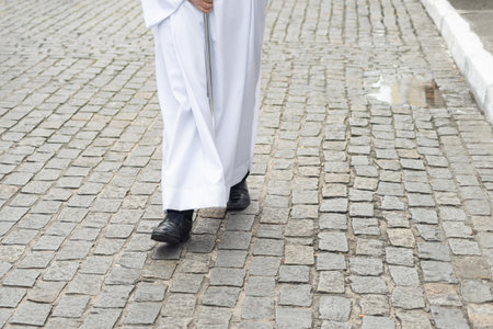 Half-length photo of an unidentified religious follower walking down the street wearing traditional clothing. Salvador, Brazilの写真素材
