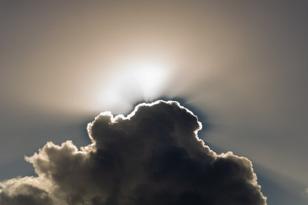 Dark clouds against bright sun and sky. Space. Background. Backdrop.の写真素材